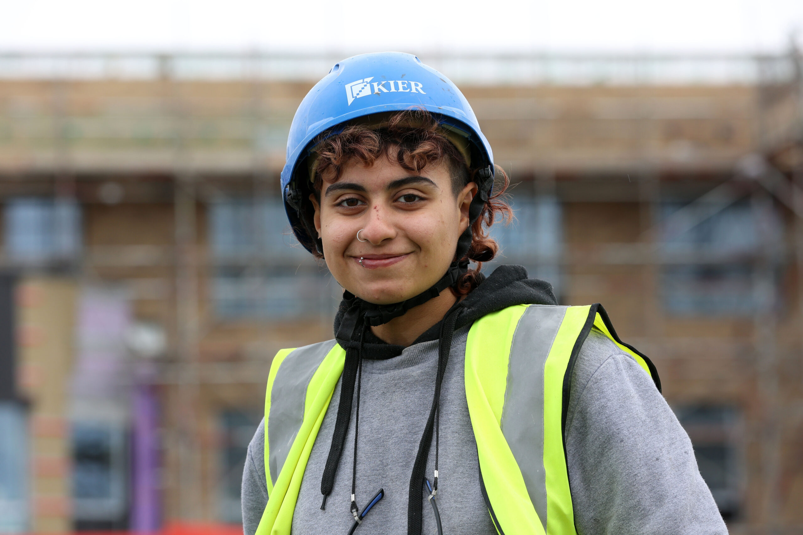 Female JGW+ construction learner, Faith working on a building site